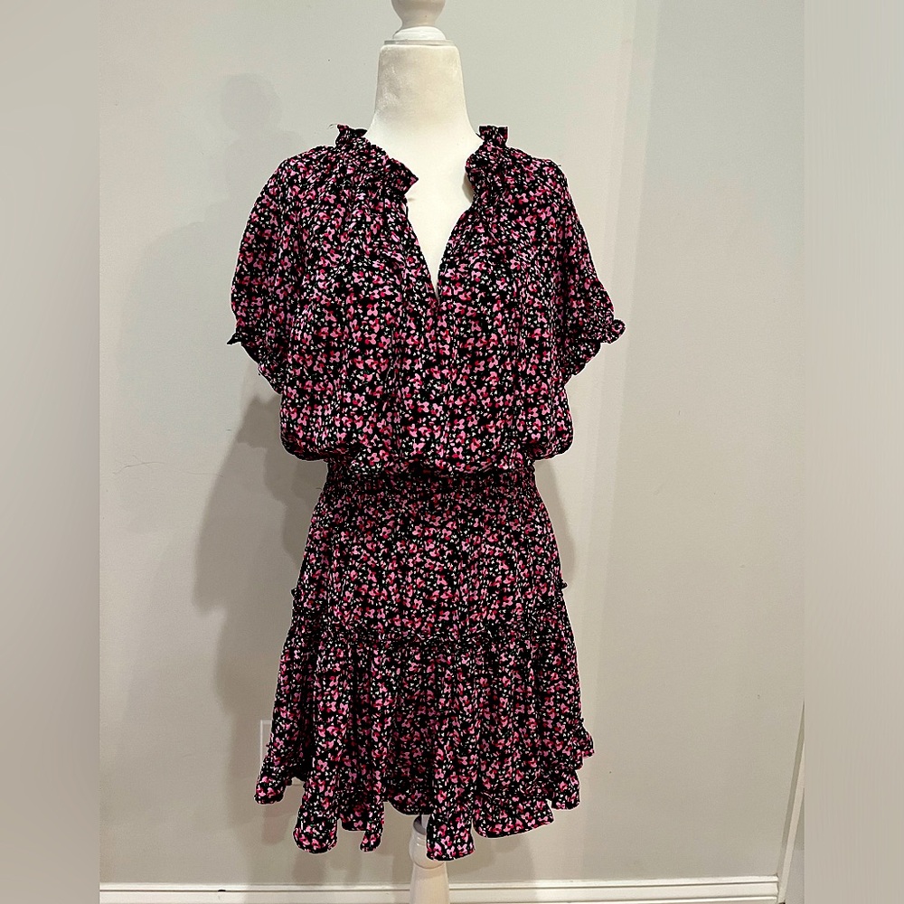 Floral pattern dress with tiered skirt and tassel strings and ruffled color.